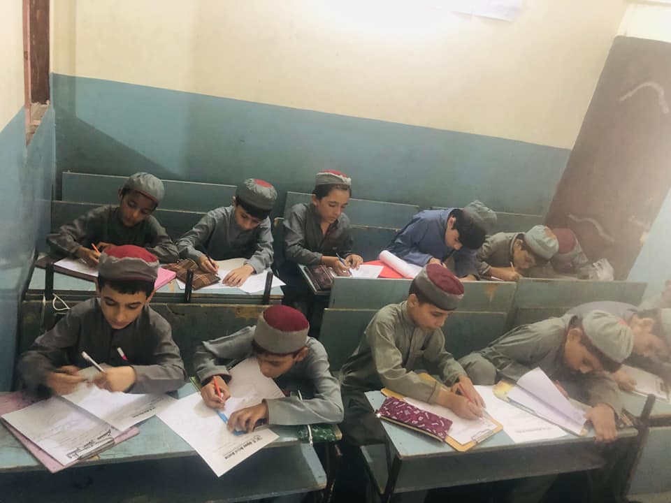 Person sitting in a modern building with a scenic view
